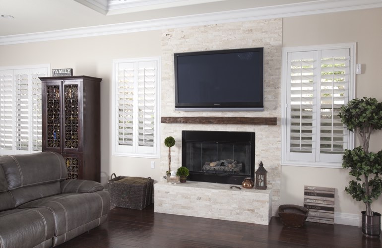 White plantation shutters in a Detroit living room with plank hardwood floors.